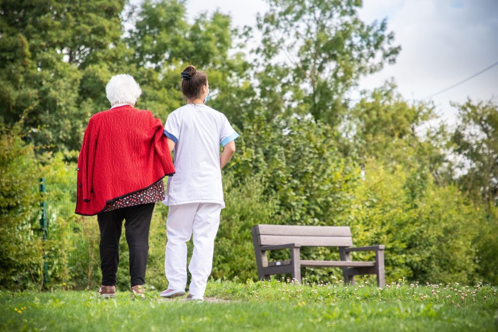 Promenade d'une personne âgée dans un espace vert près de l'EHPAD