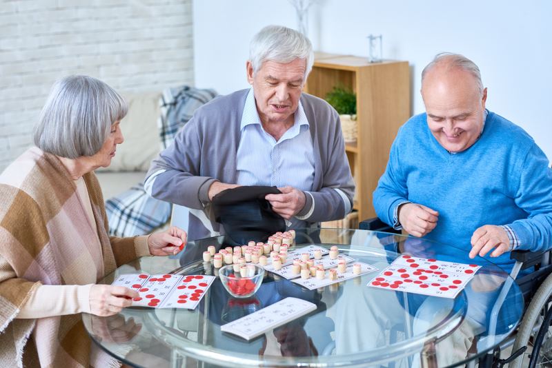 Personnes âgées en colocation seniors jouant aux cartes